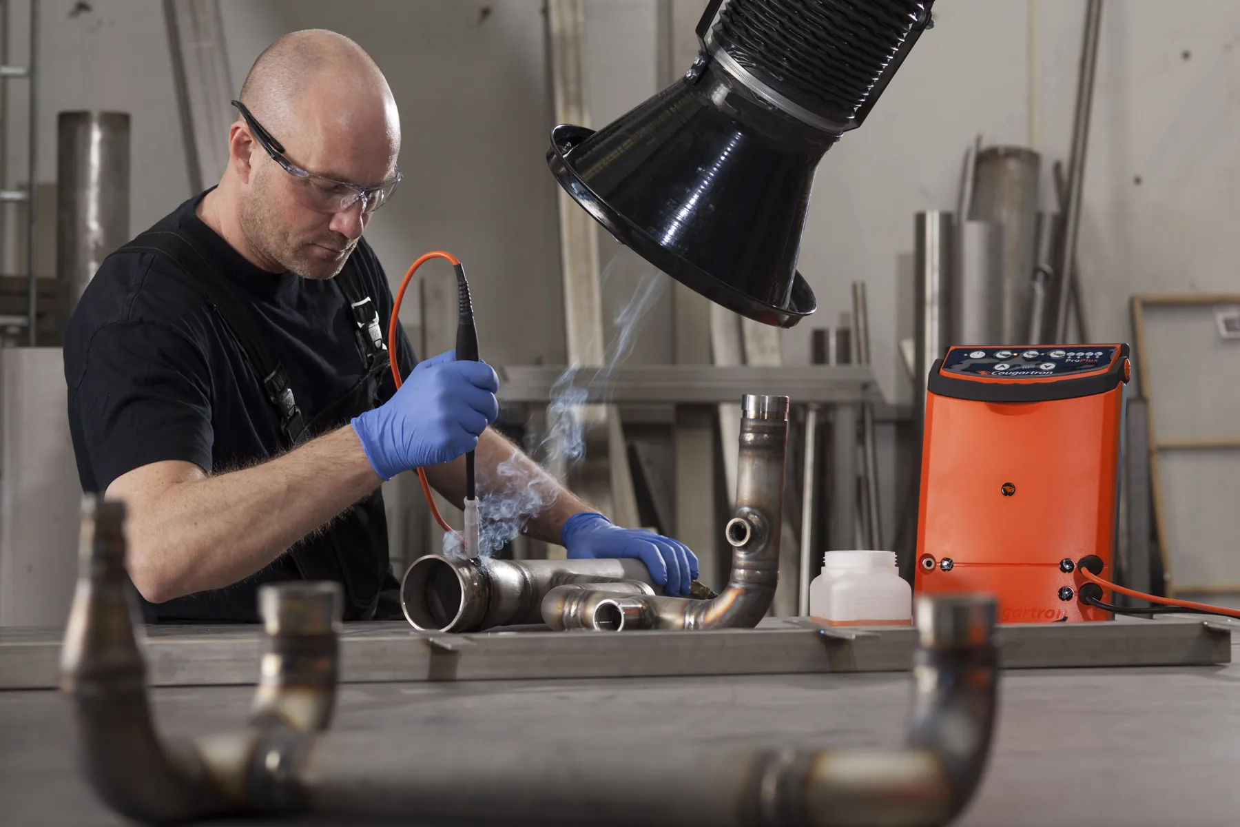 Cougartron weld cleaning equipment in use on stainless-steel pipework