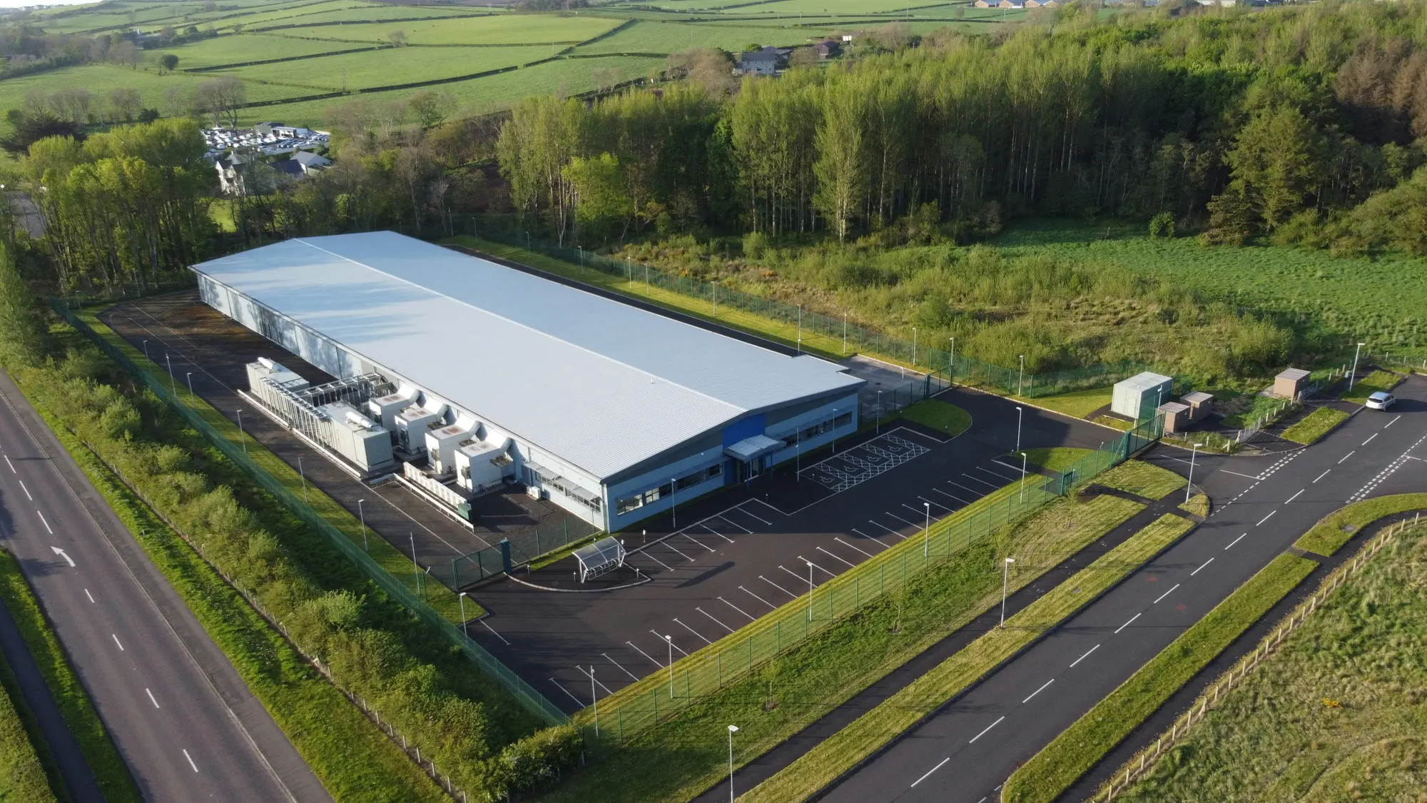 Aerial view of an industrial building with external cooling equipment